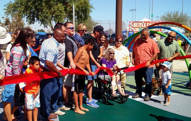 Crowd watchesAvondale City Councilwoman Sandi Nielson, who is confined to a wheelchair, cut ribbon on Friendship Park's opening day