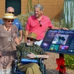 Howard Israel poses near solar walk sign